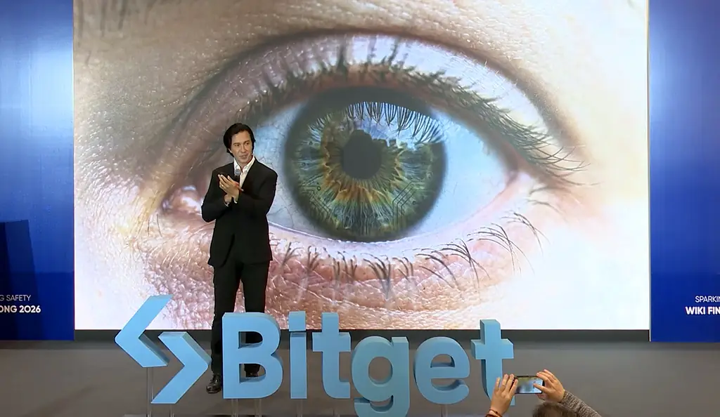 Velco Dar on stage at Wiki Finance Expo Hong Kong 2026, in front of a large image of an eye