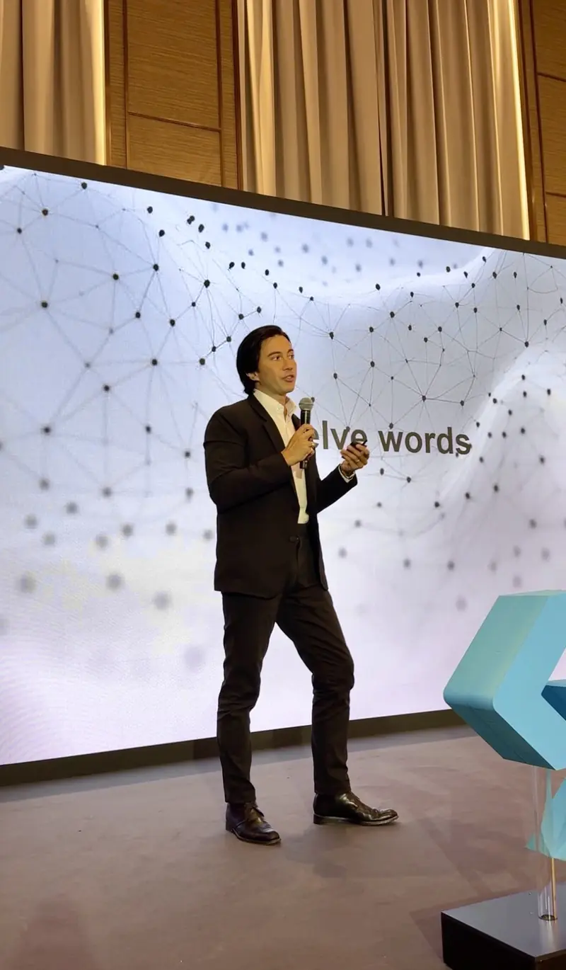 Velco Dar speaking with a microphone at Wiki Finance Expo Hong Kong 2026